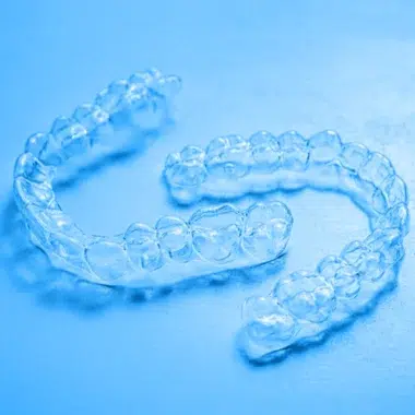 Clear retainers with blue background | Space City Orthodontics - Houston and Clear Lake, Texas